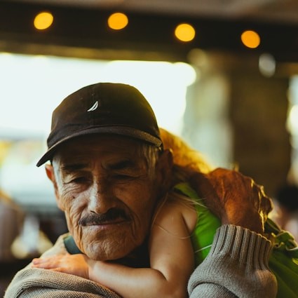 Hispanic grandfather holding child